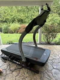 a tread machine sitting on a porch